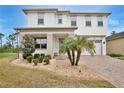 Charming two-story home with well-maintained lawn and landscaping, and a brick driveway at 14384 Alafaya Oak Bnd, Orlando, FL 32828