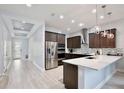 Bright kitchen boasts stainless steel appliances, a mosaic backsplash, and an open layout at 14384 Alafaya Oak Bnd, Orlando, FL 32828