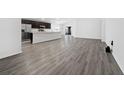Open-concept living area with modern flooring, neutral walls, and ample natural light, perfect for entertaining at 1760 Astrid Rd, Davenport, FL 33837