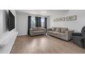 Bright living room with two sofas, neutral walls, and contemporary flooring at 1838 Warringwood Dr # B-3, Orlando, FL 32839