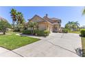Side view of a charming home with a spacious driveway, lush landscaping, and a well-maintained lawn at 2368 Buckingham Run Ct, Orlando, FL 32828
