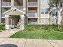 Inviting condo exterior featuring lush landscaping and multiple balconies and entry area at 4280 Summer Landing Dr # 204, Lakeland, FL 33810