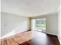 Empty living room with wood floors and sliding glass doors to balcony at 4280 Summer Landing Dr # 204, Lakeland, FL 33810