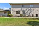 Exterior shot of a townhome featuring trimmed bushes and vinyl siding at 4353 Shadow Crest Pl # 3, Orlando, FL 32811