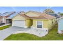 Charming home featuring a well-maintained lawn, two-car garage, and neutral color scheme at 458 Hollinghead Loop, Davenport, FL 33896