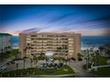 Exterior shot of the condo building at dusk, highlighting its architecture, balconies, and oceanfront location at 4651 S Atlantic Ave # 2030, Ponce Inlet, FL 32127