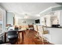 Bright living room featuring hardwood floors, custom window shutters and cozy seating near a convenient bar area at 4651 S Atlantic Ave # 2030, Ponce Inlet, FL 32127