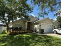 Charming one-story home with a well-maintained lawn and lush landscaping in a tranquil setting at 536 Dunoon St, Ocoee, FL 34761