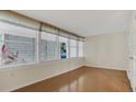 Bright sun room with hardwood floors and wall-to-wall windows at 5569 Jessamine Ln, Orlando, FL 32839