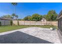 Spacious backyard featuring a new paved patio and a wood fence for privacy at 825 Rosemere Cir, Orlando, FL 32835