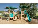 Community playground with slides, climbing structures, and shade canopies offers outdoor fun for families at 872 Scrub Oak Hammock Rd, Davenport, FL 33837