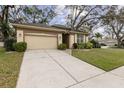 Well-maintained single-story home with attached garage, lush lawn, and inviting curb appeal at 892 Cool Springs Cir, Ocoee, FL 34761