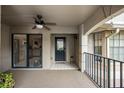 Covered patio area features ceiling fan, tile flooring, and sliding glass doors to the kitchen at 1075 Kensington Park Dr # 203, Altamonte Springs, FL 32714