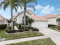 Inviting single-Gathering home with beautiful landscaping, a two-car garage, and a secure gated side entrance at 13336 Lake Turnberry Cir, Orlando, FL 32828