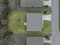 Aerial view of the house showcasing its layout, surrounding green lawn, and proximity to neighboring properties at 1385 Evergreen Park Cir, Lakeland, FL 33813