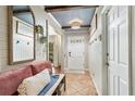 Welcoming foyer with a mirror and bench, coat hooks, and tile flooring at 142 Habersham Dr, Longwood, FL 32779