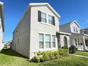 Charming two-story home with gray stucco exterior, stone archway, and manicured front lawn at 15127 Book Club Rd, Winter Garden, FL 34787