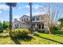 Two story home with blue shutters, mature landscaping and a manicured lawn at 2040 Touchwood Ct, Apopka, FL 32712