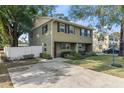 Inviting two-story townhome showcases mature trees and well-manicured landscaping at 210 N East St, Maitland, FL 32751