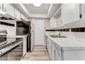 Kitchen featuring stainless steel appliances, tile countertops, and white cabinetry at 225 Ranier Cv # 105, Casselberry, FL 32707