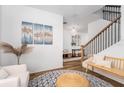 Open foyer featuring wood flooring, a staircase with iron railings, and elegant decor at 2273 Lost Horizon Way, Clermont, FL 34715