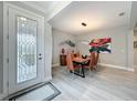 Dining room with a modern light fixture, artistic accents, and a decorative front door at 2348 Clemblue Rd, Clermont, FL 34715