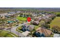 A picturesque aerial view of a neighborhood featuring a vibrant green park and neatly arranged homes at 3000 Stonington Run, Kissimmee, FL 34746