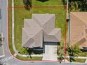 An aerial view of a home's roof and property lines, showcasing its location on a corner lot at 3000 Stonington Run, Kissimmee, FL 34746