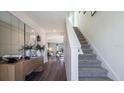 Inviting entryway featuring wood floors and a staircase to the upper level at 3166 Partington Blvd, Davenport, FL 33837