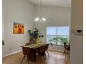 Cozy dining room area featuring pendant lighting and a large window with garden views at 3210 Little Oak Way, Orlando, FL 32812