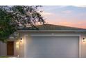 Charming exterior of the home at sunset with a two car garage and well-maintained yard at 3722 Madbury Cir, Lakeland, FL 33810