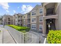 Attractive condo building with multiple balconies and well-maintained landscaping at 584 Brantley Terrace Way # 209, Altamonte Springs, FL 32714