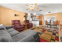 Cozy open-concept living room flowing into a kitchen and dining area with lots of natural light at 8430 Pamlico St, Orlando, FL 32817