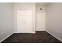 Empty bedroom with grey walls, carpet flooring and double door closet at 8775 Sartori St # 208, Orlando, FL 32829