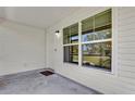 Covered porch featuring a bright white exterior, large windows, and concrete flooring at 901 S Holly Ave, Sanford, FL 32771