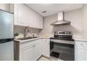 Cozy kitchen featuring stainless steel appliances, white cabinets, and a stainless-steel sink at 942 Lake Destiny Rd # B, Altamonte Springs, FL 32714