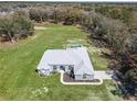 Aerial view of the beautiful home with a spacious yard and lush greenery at 10688 Sw 129Th Terrace Rd, Dunnellon, FL 34432