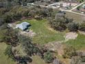 Expansive property featuring a well-maintained home and a sprawling green landscape at 10688 Sw 129Th Terrace Rd, Dunnellon, FL 34432