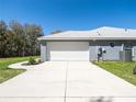 Spacious two-car garage with a wide driveway and well-maintained exterior at 10688 Sw 129Th Terrace Rd, Dunnellon, FL 34432