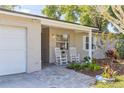 Covered front entry with rocking chairs and bricked walkway at 116 Cambridge Dr, Longwood, FL 32779