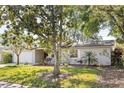 Beautiful single story home with brick accents, a well manicured front yard, and a welcoming porch with rocking chairs at 116 Cambridge Dr, Longwood, FL 32779