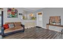 Cozy living area with wood floors and barstool seating open to the kitchen at 119 Mayfair Cir, Sanford, FL 32771