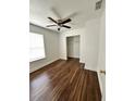 Bright bedroom with wood floors, ceiling fan, closet, and window providing natural light at 1352 Sw 69Th Rd, Bushnell, FL 33513