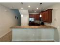 Kitchen featuring stainless steel appliances, dark wood cabinets, and a breakfast bar at 15198 Harrington Cove Dr, Orlando, FL 32824