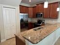 Modern kitchen with stainless steel appliances, granite countertops, and ample cabinet space at 15198 Harrington Cove Dr, Orlando, FL 32824