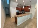 Charming kitchen with modern appliances, breakfast bar and tile flooring at 15198 Harrington Cove Dr, Orlando, FL 32824