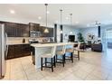 Open concept kitchen with breakfast bar, stainless steel appliances and direct view into the living area at 1602 Lima Ave, Kissimmee, FL 34747