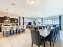 Open concept living room and kitchen area offering spacious design and sliding glass doors to backyard pool at 1602 Lima Ave, Kissimmee, FL 34747