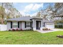 Beautifully landscaped single-story home with a two-car garage and inviting entrance at 1621 Crescent Rd, Longwood, FL 32750