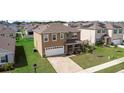 Well-maintained home with a spacious lawn, attached garage, and inviting front porch at 2024 Griffin Oaks Way, Tavares, FL 32778